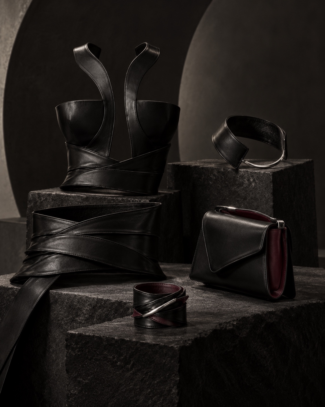 Second Skin objects arranged on dark stone forms
